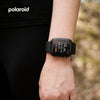 PA86 Polaroid Fit Active Watch on a wrist with a blurred natural background, featuring the Polaroid brand.