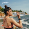 Woman drinking water by the beach wearing the Polaroid PA88 Watch.