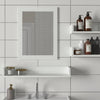 Bathroom vanity with mirror and shelves against a tiled wall