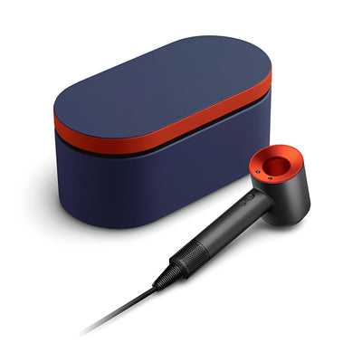 Black and red hair dryer with a blue carrying case on a white background