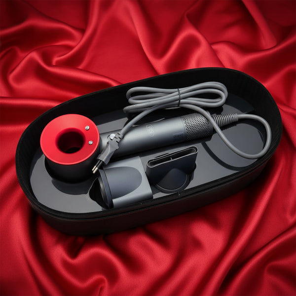 Black and gray Hair Dryer with red component on a red satin background