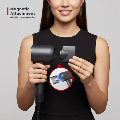 Woman holding a hair dryer with a magnetic attachment feature on a gray background